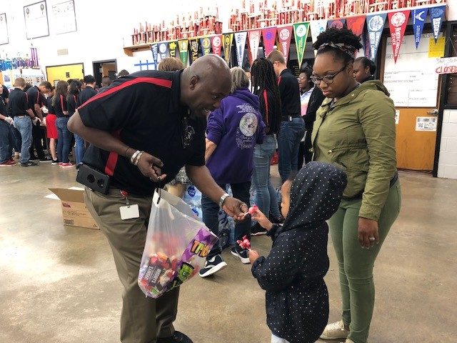 Chief Warrent Officer Ronald McMiller hands out candy as NJROTC makes brown paper bag lunches for those in need during the winter. “He has a very demanding but strong vibe that makes everyone want to follow his courageous leadership,” said senior Jonathon Ramirez. 